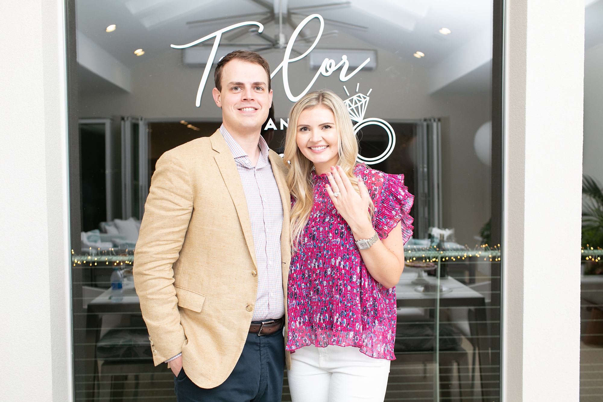 bride holds up engagement ring during Dallas surprise engagement party