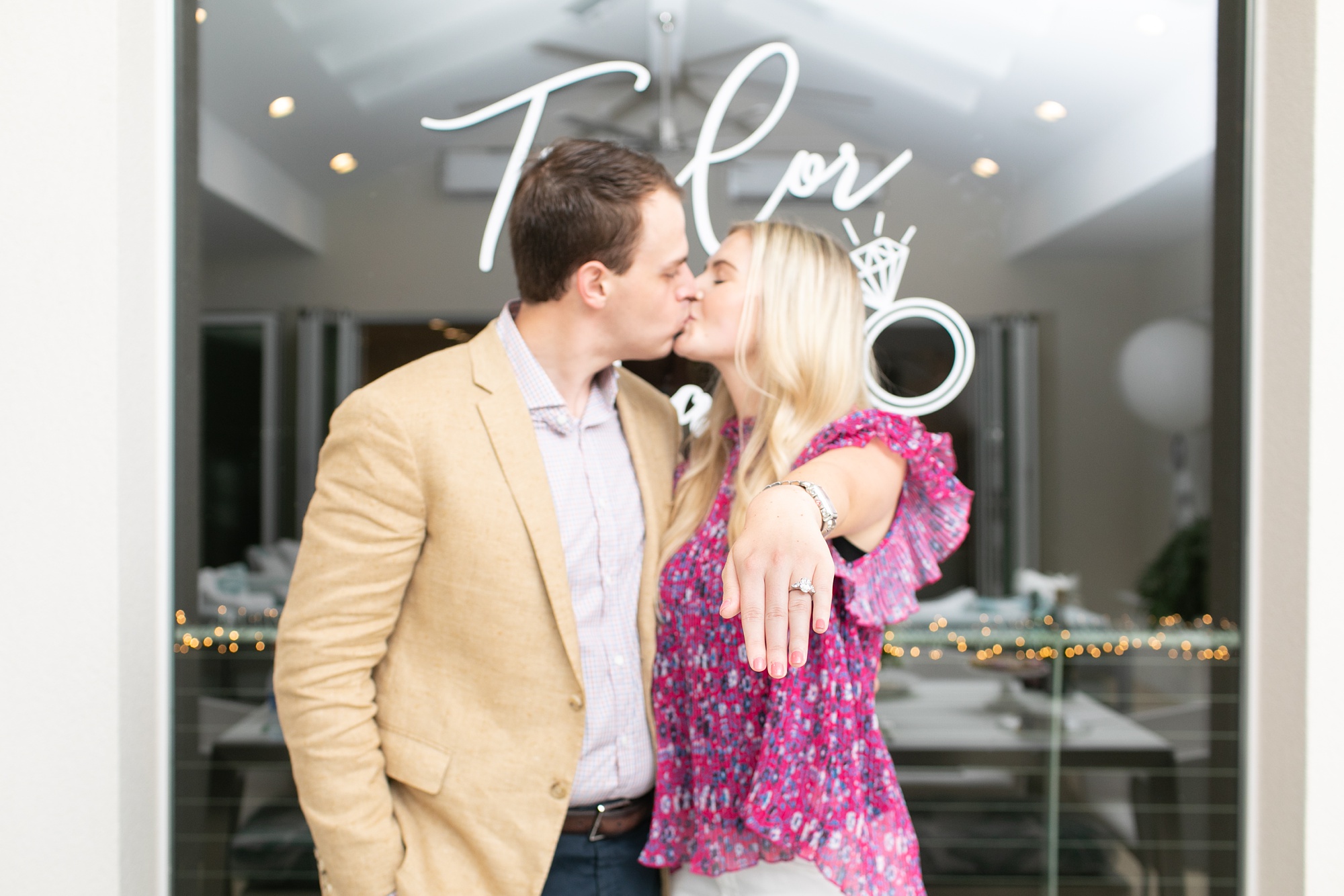 engaged couple kisses at the end of Dallas surprise engagement party