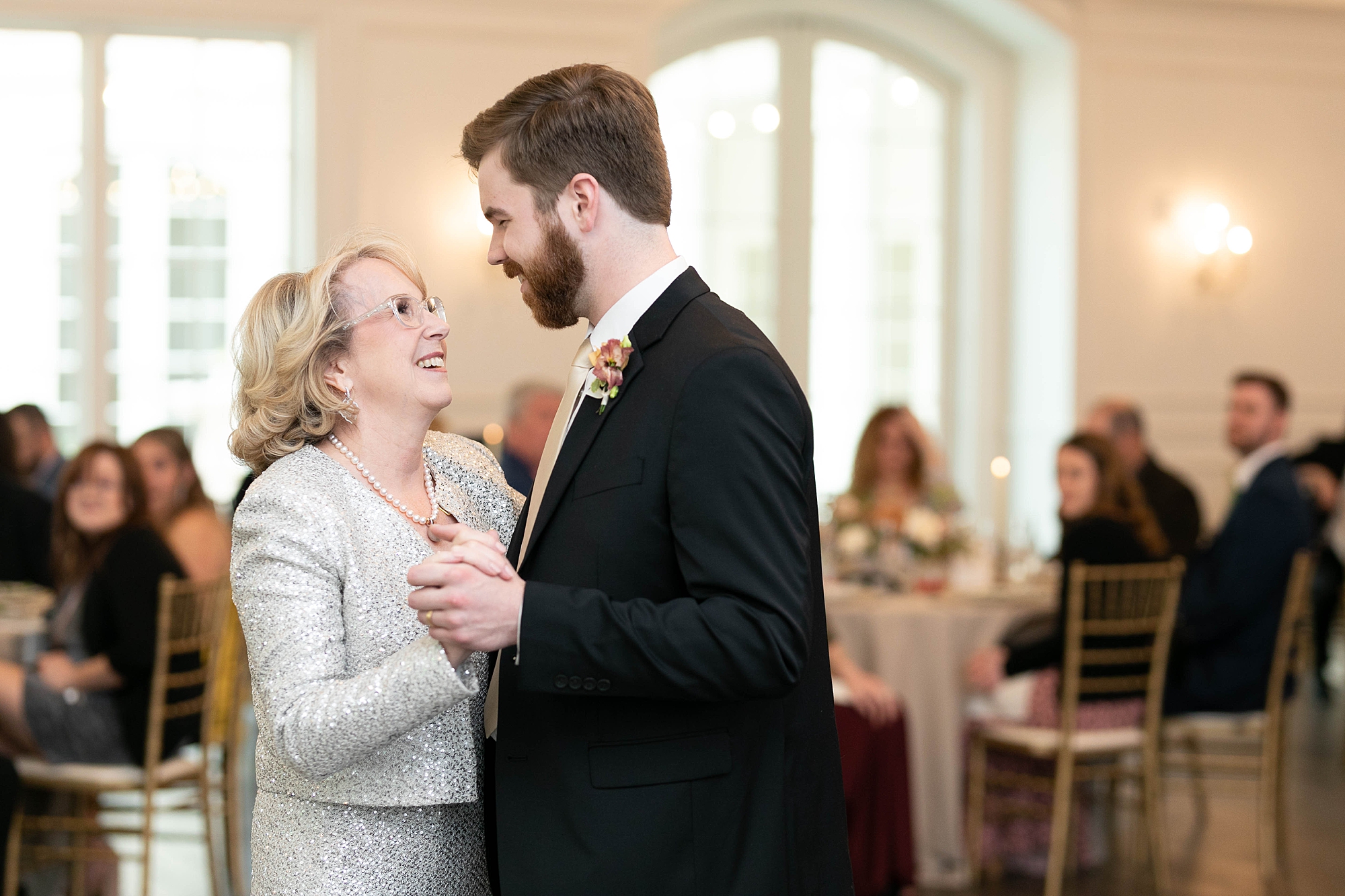 mother smiles at groom during dance at Denton TX wedding reception