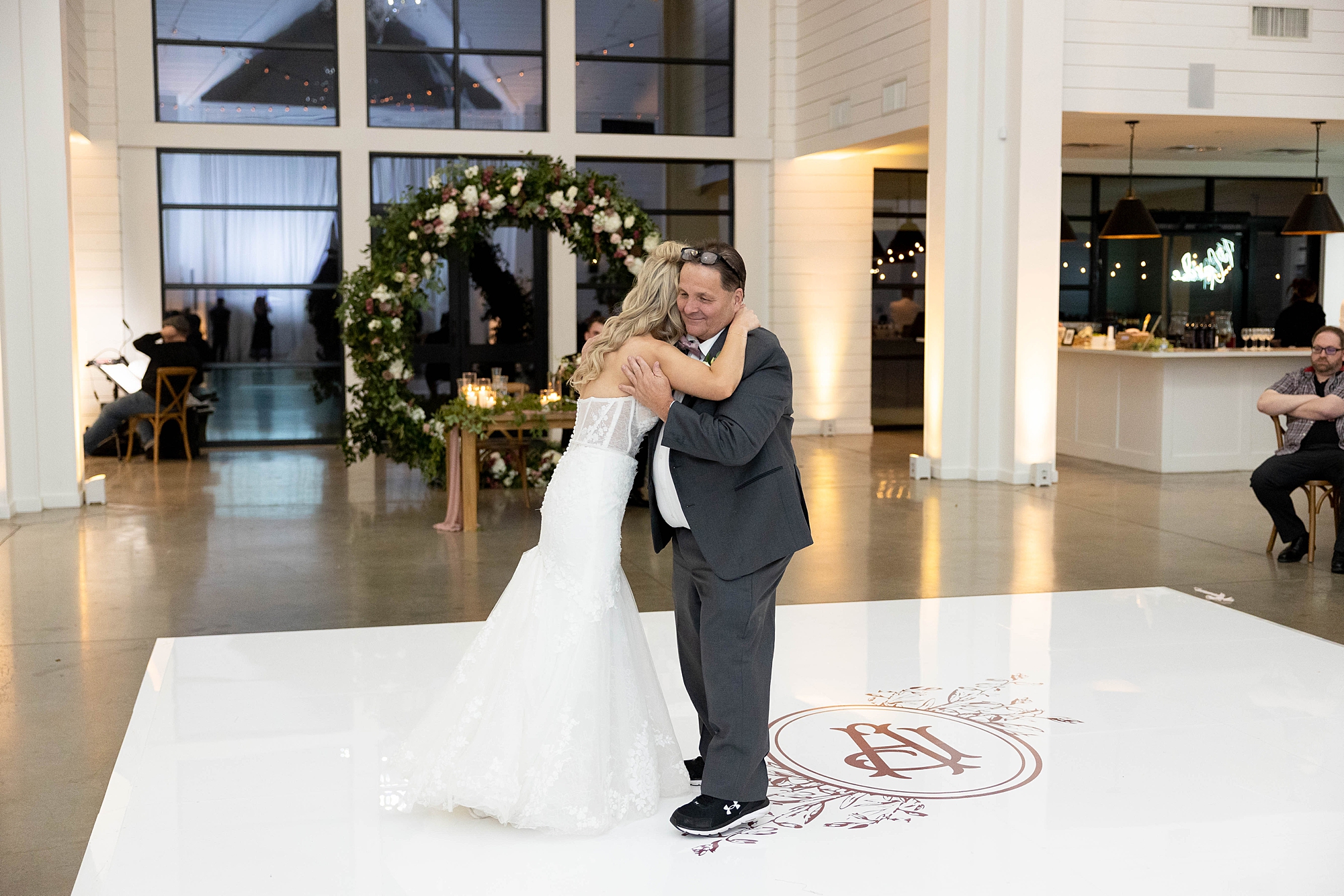 bride hugs father during dance at Dallas TX wedding reception