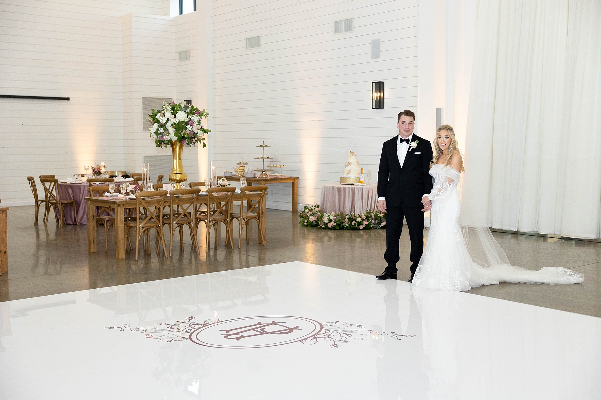 bride and groom walk onto custom dance floor inside the Gardenia