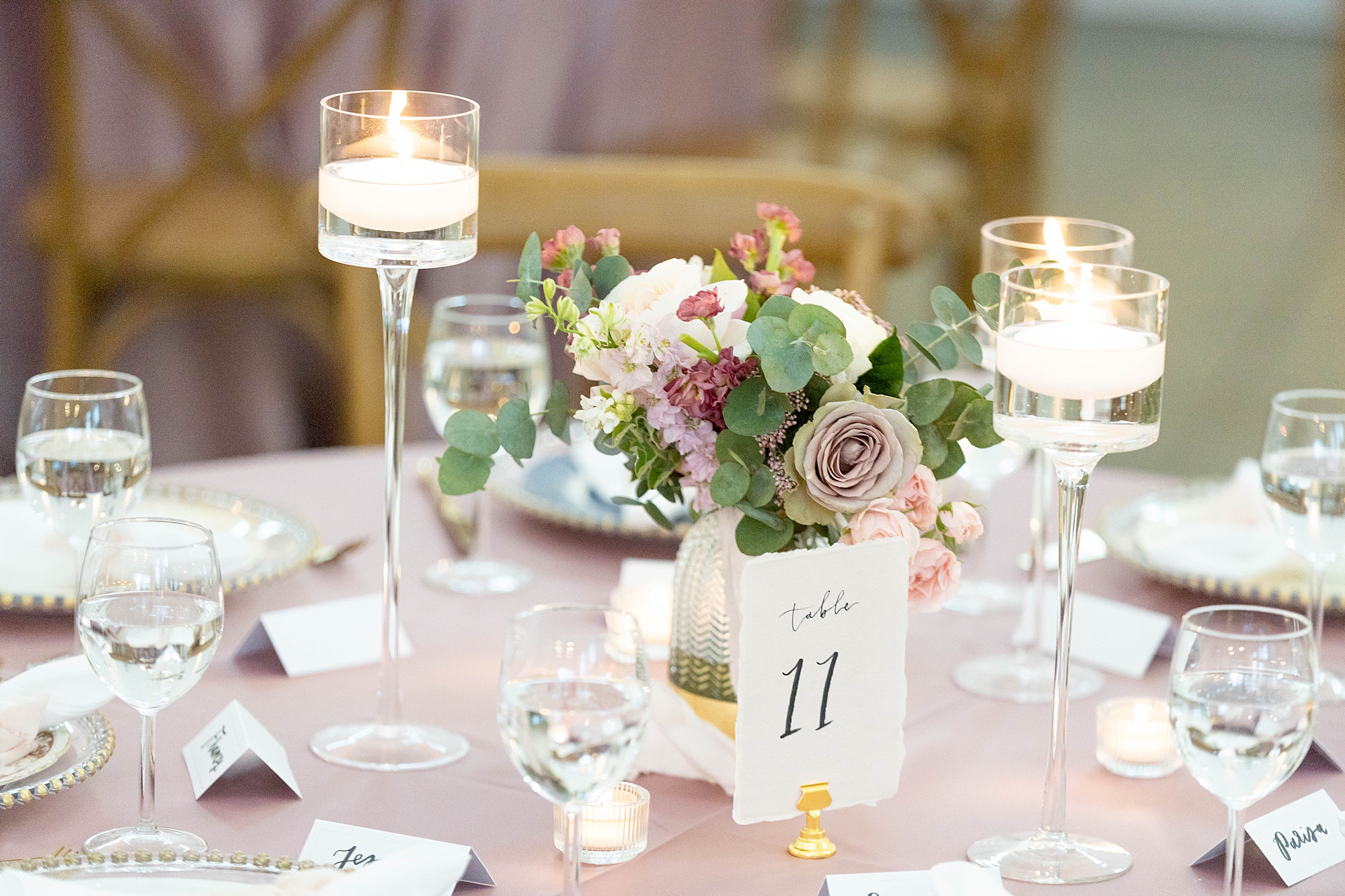 wedding reception with pink flowers, floating candles, and gold accents at the Gardenia
