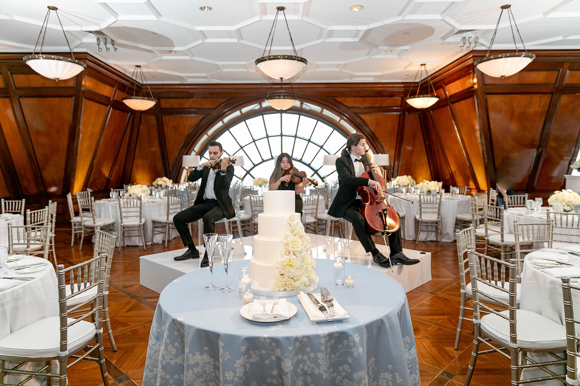 string trio plays inside the Crescent Club during wedding reception