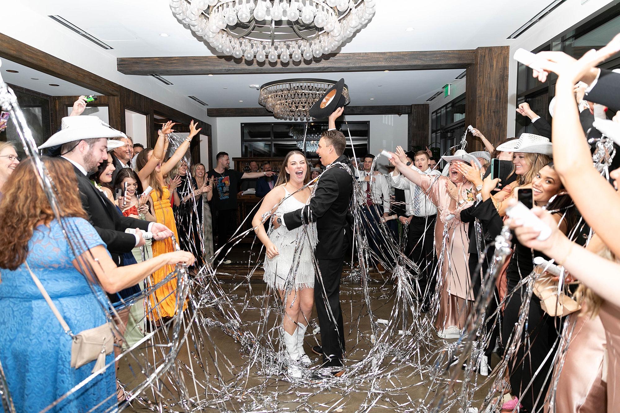 bride and groom laugh after being covered in streamers at the Hotel Dover