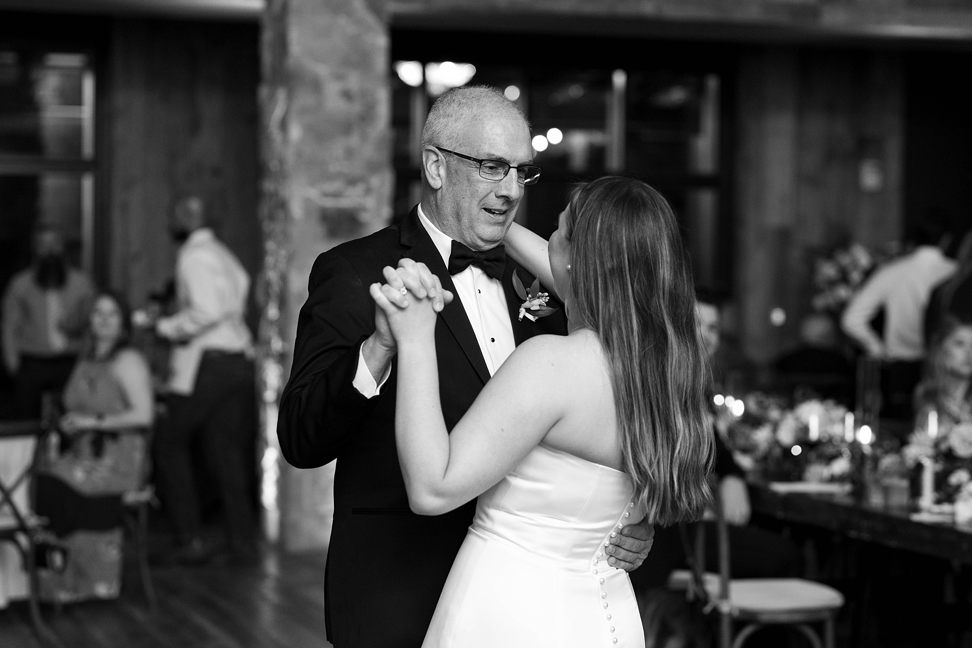 bride and father dance during wedding reception in the barn at the Hotel Drover