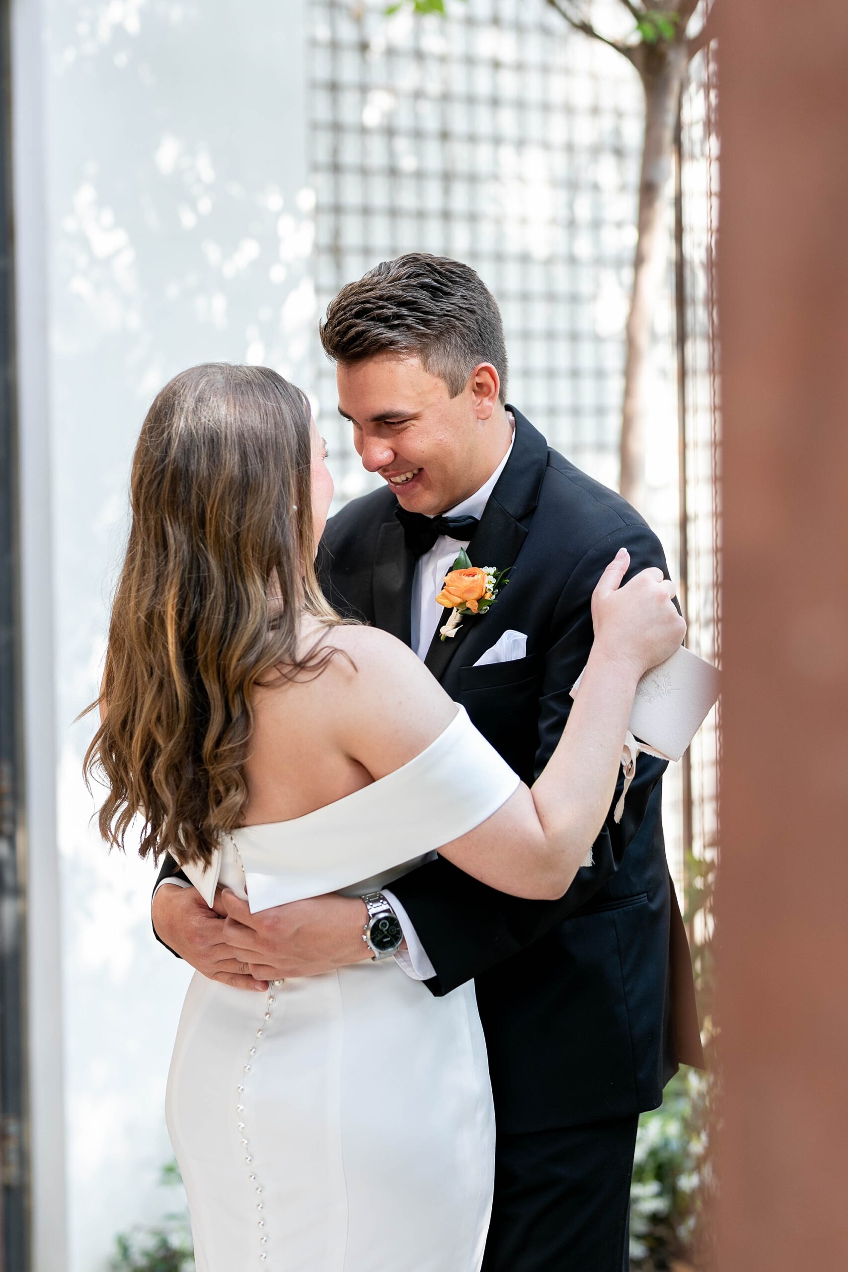 bride and groom hug during first look at the Hotel Drover