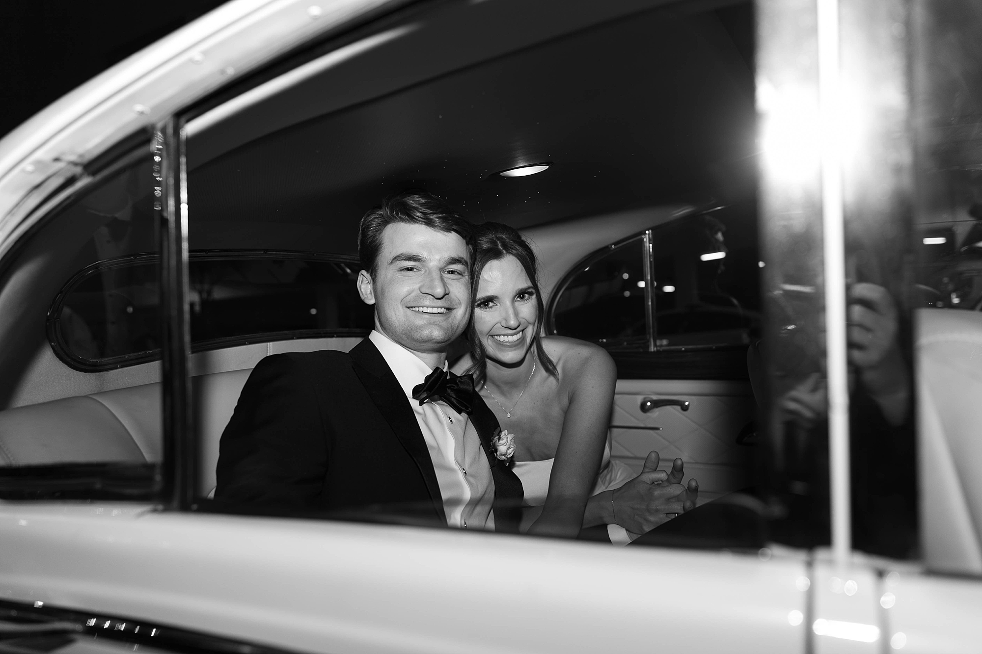 bride and groom hug inside classic car during Dallas wedding day