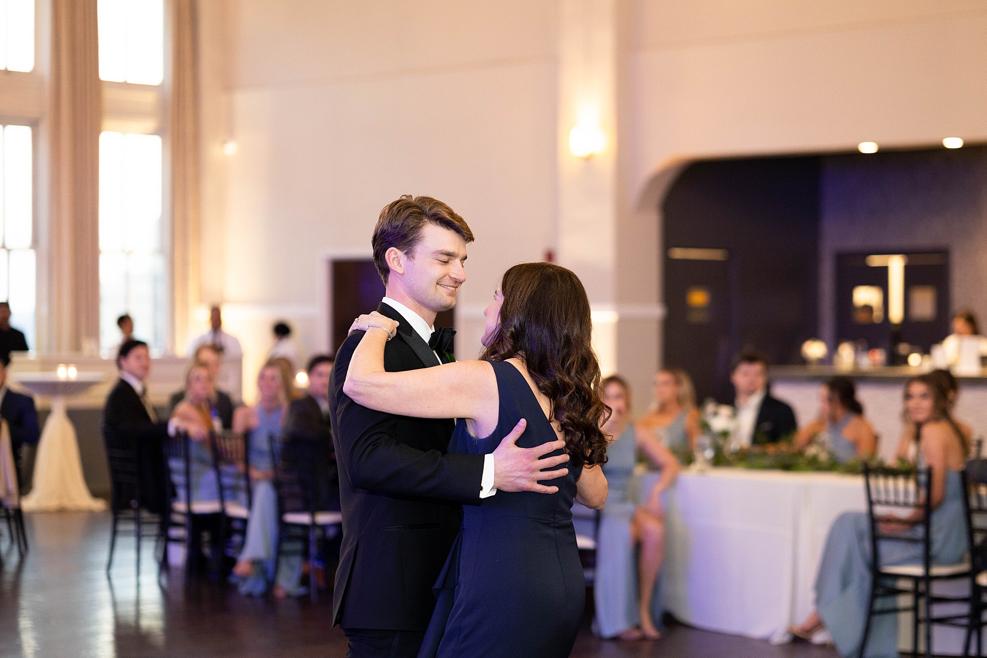 groom dances with mother during wedding reception at the Room on Main
