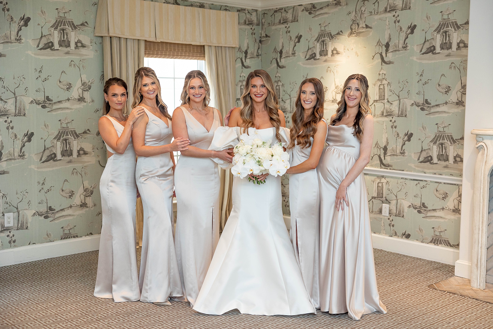 bride stands with bridesmaids in silk gowns inside Rosewood Mansion