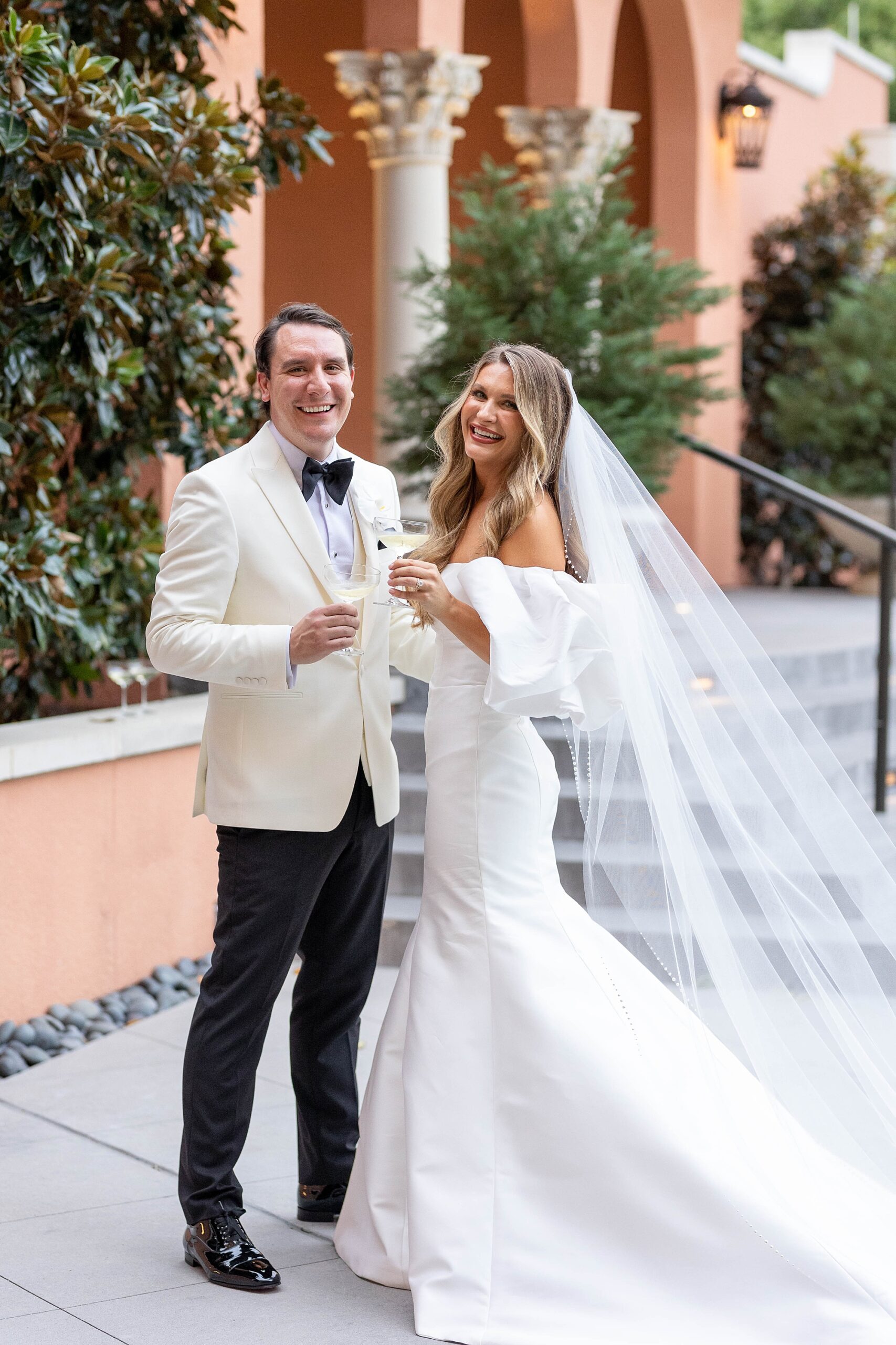 bride and groom toast champagne glasses during Dallas wedding day