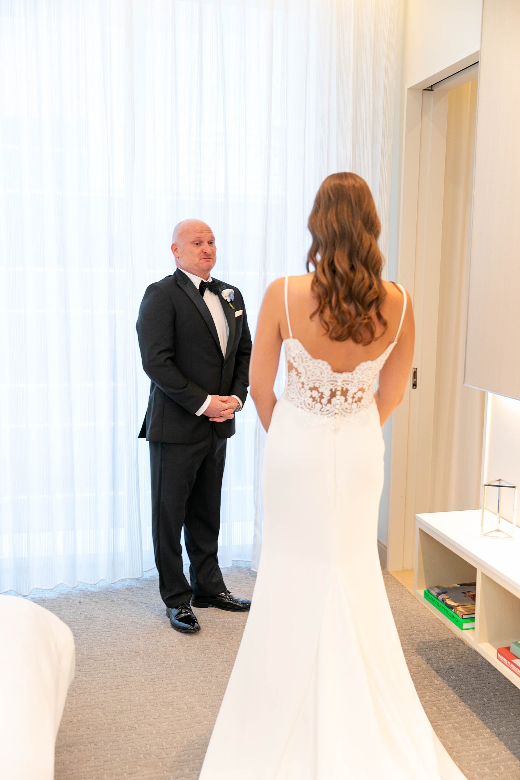 bride approaches father for first look inside Dallas hotel