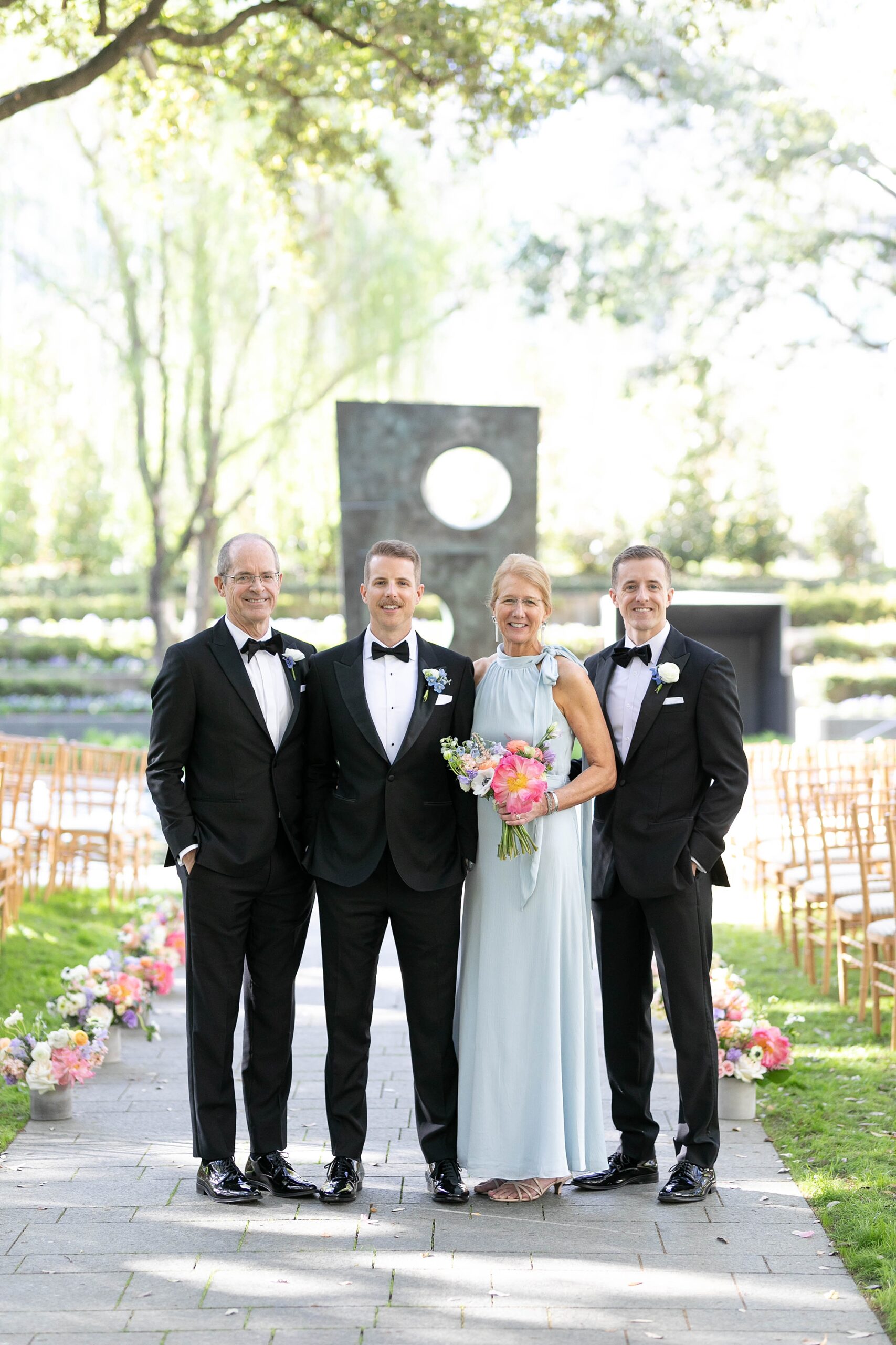 groom stands with family inside Nasher Sculpture Center