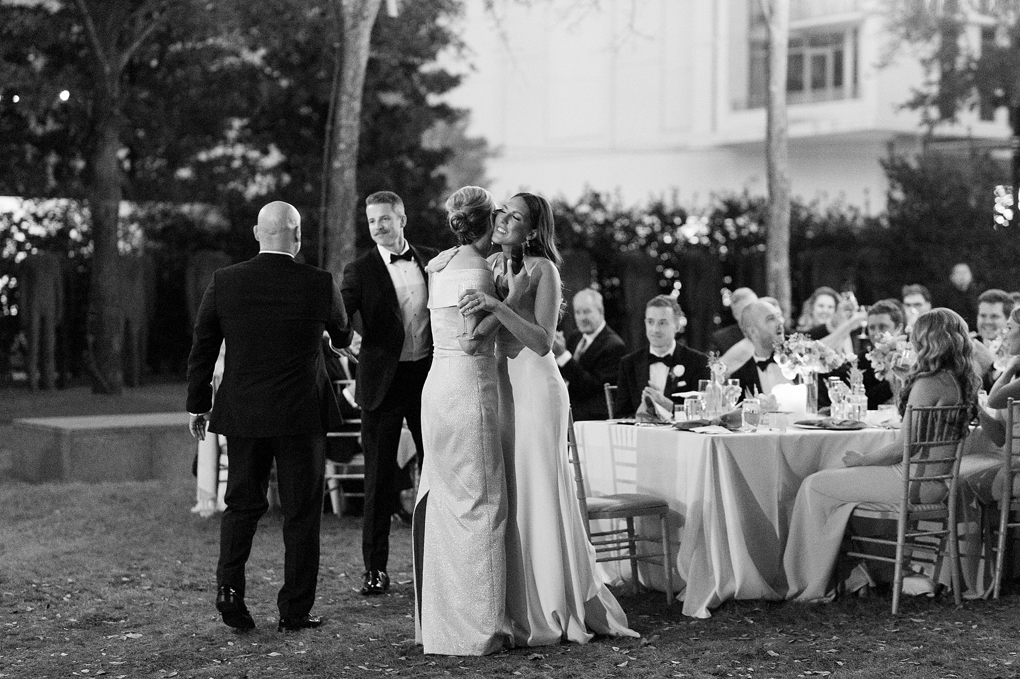 bride hugs parents during al fresco wedding reception at the Nasher Sculpture Center