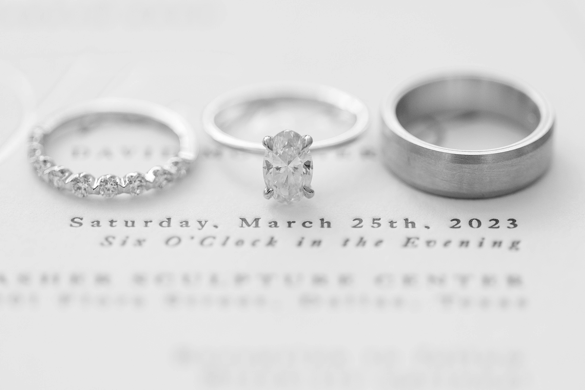 three wedding rings lay on invitation suite at the Nasher Sculpture Center