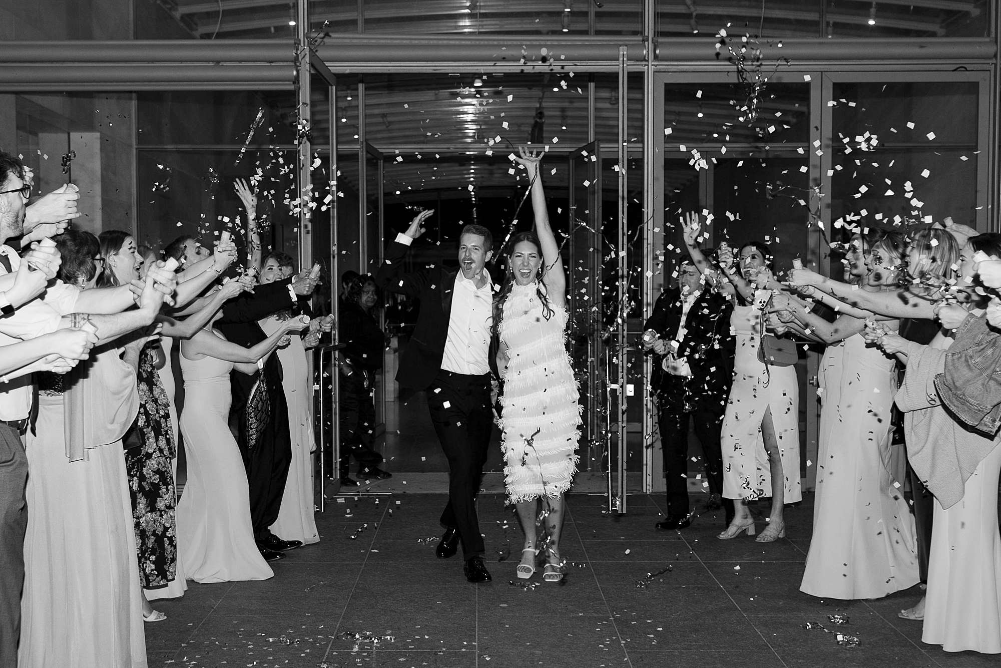 newlyweds cheer during confetti exit from the Nasher Sculpture Center