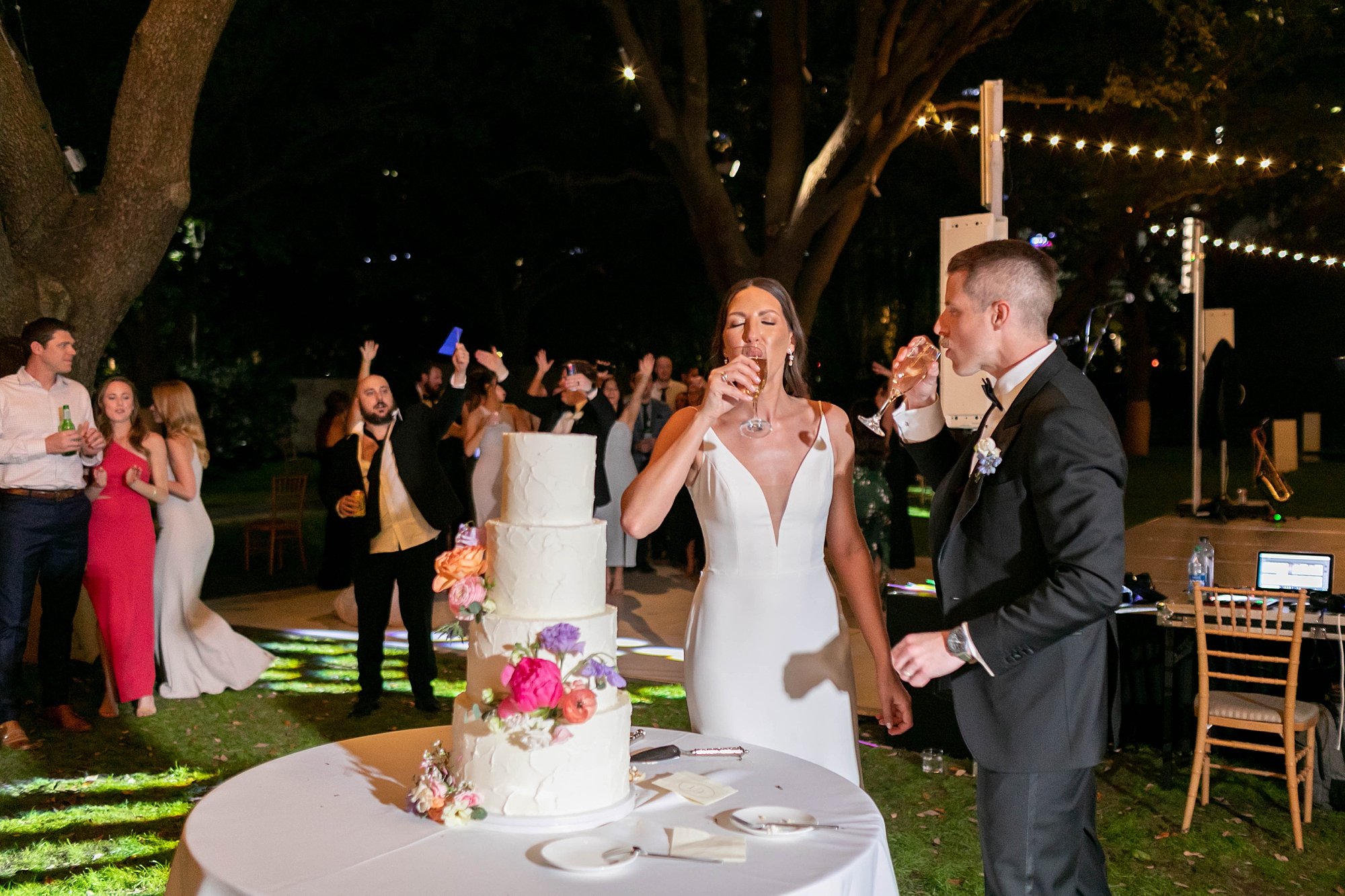 bride and groom eat wedding cake during outdoor Dallas wedding reception 