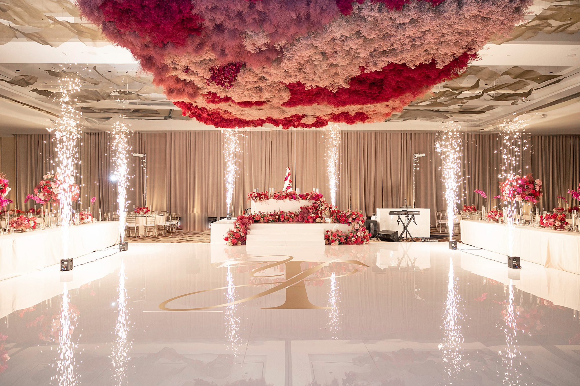 wedding reception at the Omni Frisco at the Star with pink hanging floral installation 