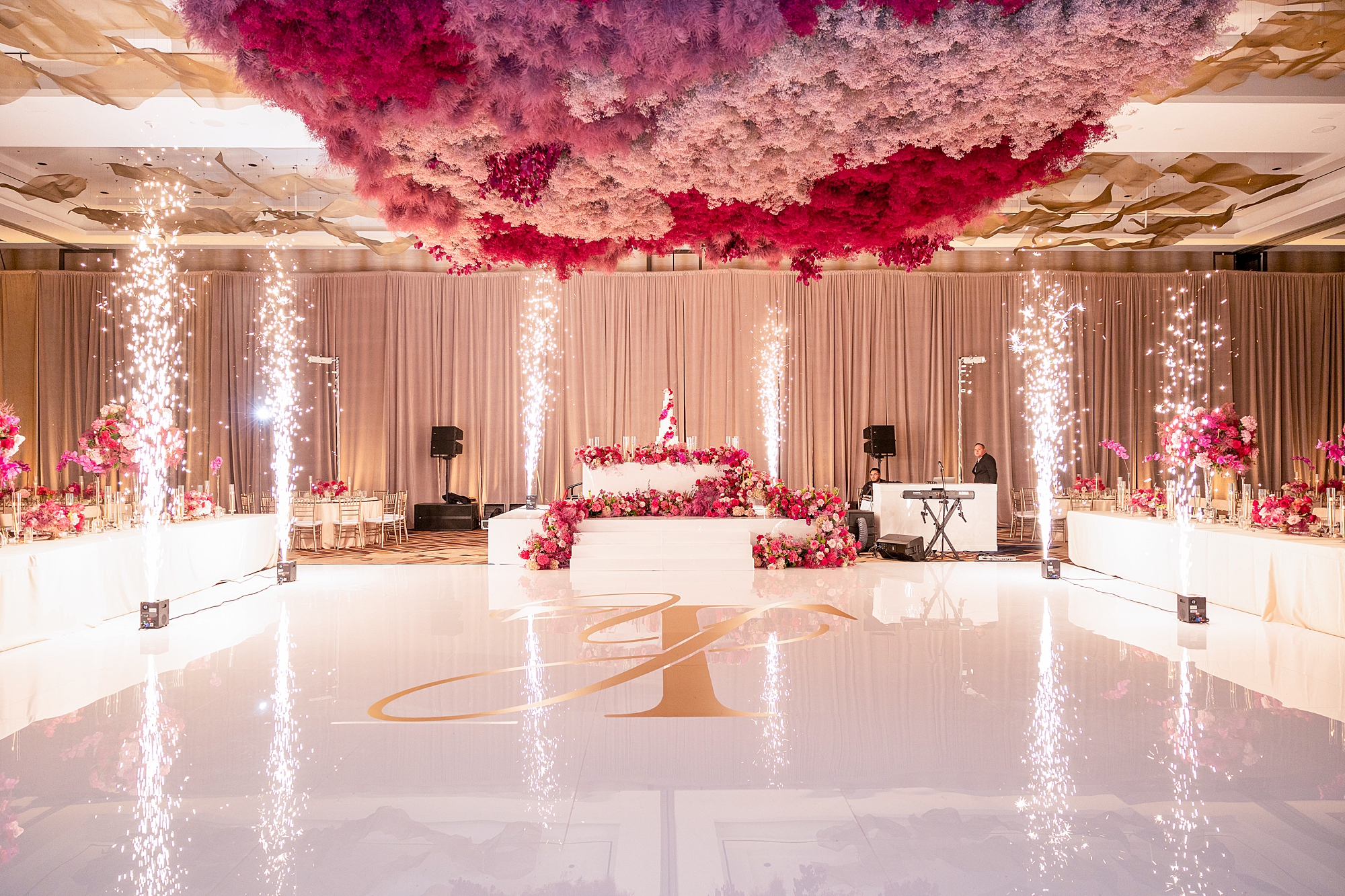 wedding reception with pink floral installation in ballroom at the Omni Frisco at the Star