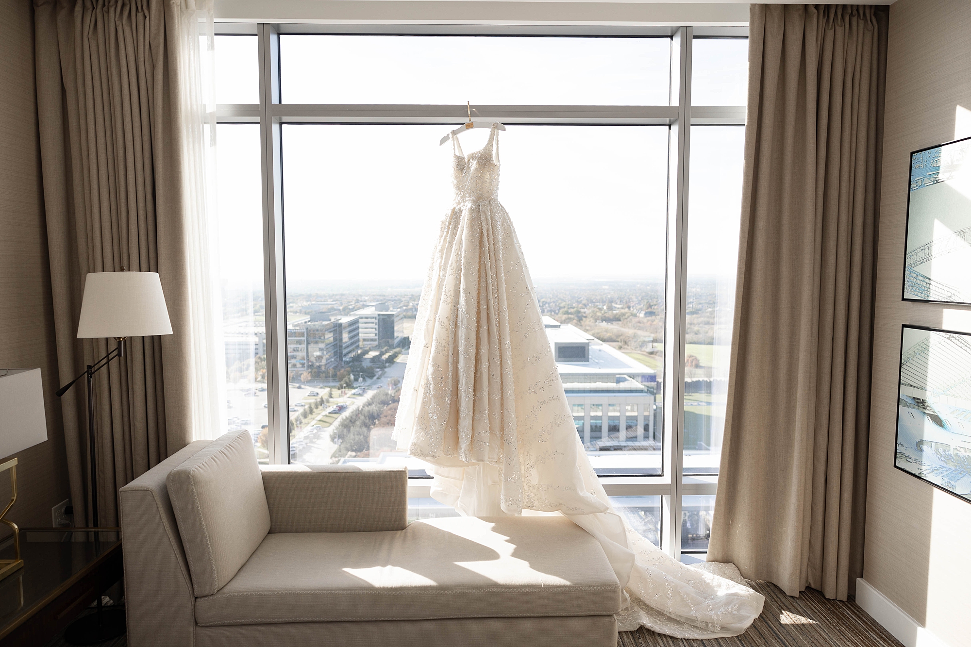 ball gown hangs in window of the Omni Frisco at the Star